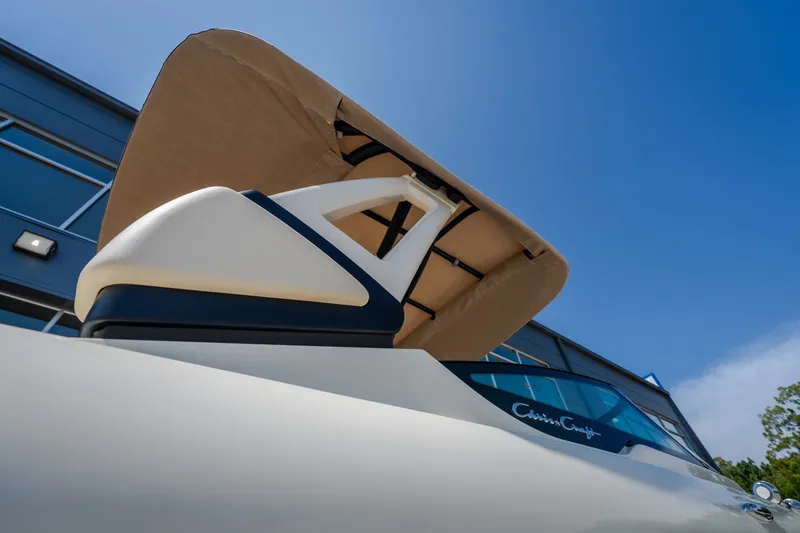 Slide: The Image of 2026 Chris-Craft Sportster 28 boat with canopy, viewed from below against blue sky. - 10