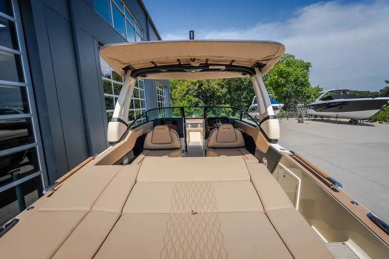 Slide: The Image of 2026 Chris-Craft Sportster 28 boat with luxurious seating and sleek design, docked outdoors. - 12