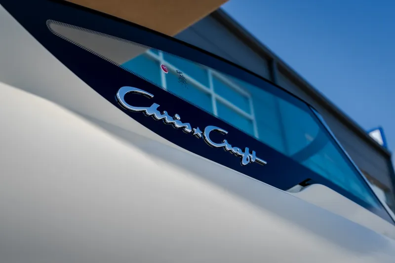 Slide: The Image of 2026 Chris-Craft Sportster 28 boat, close-up of logo on sleek design. - 11