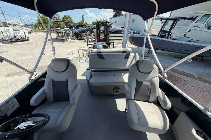 Slide: The Image of Interior view of a 2022 Sylvan L3 DLZ pontoon boat with seating and steering wheel. - 16