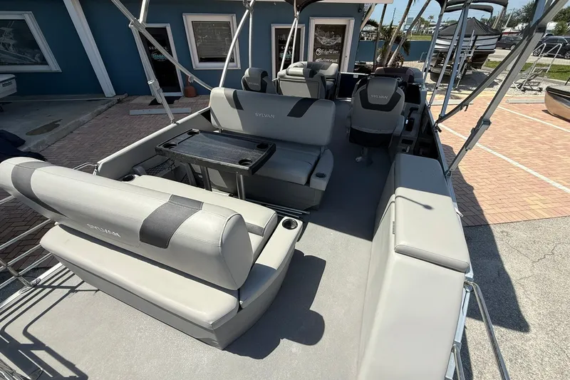 Slide: The Image of 2022 Sylvan L3 DLZ pontoon boat interior with seating and table. - 9