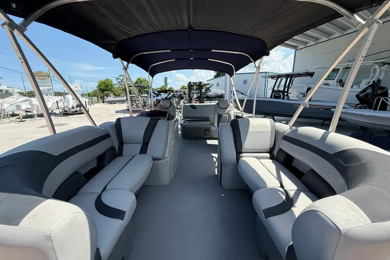 Slide: The Image of 2022 Sylvan L3 DLZ pontoon boat interior with spacious seating and canopy. - 22