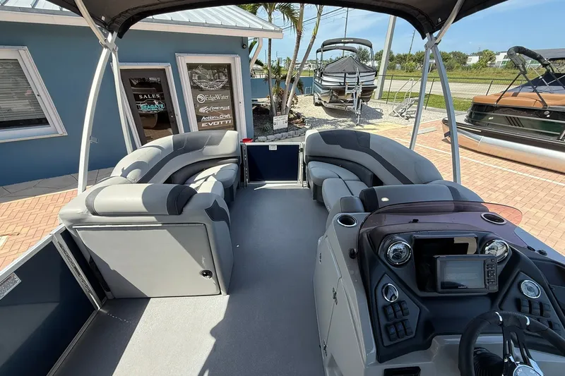 Slide: The Image of 2022 Sylvan L3 DLZ pontoon boat interior with modern seating and control panel. - 19