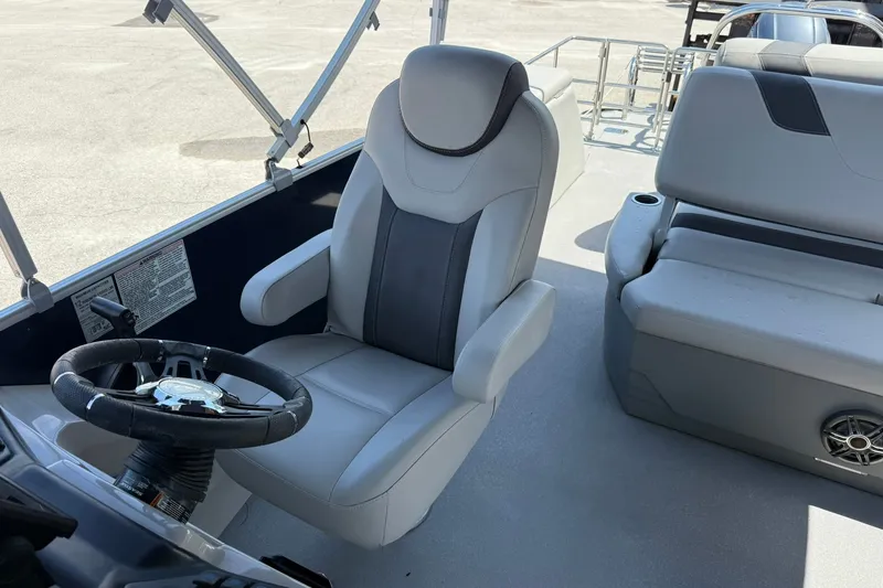 Slide: The Image of 2022 Sylvan L3 DLZ boat interior with steering wheel and seating. - 17