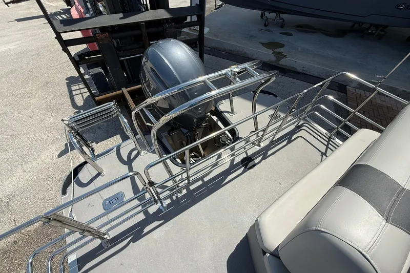 Slide: The Image of 2022 Sylvan L3 DLZ pontoon boat with outboard motor and seating area. - 7
