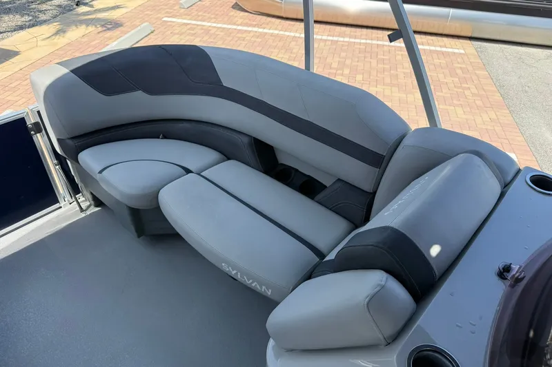 Slide: The Image of Luxurious seating on 2022 Sylvan L3 DLZ pontoon boat, featuring sleek gray and black upholstery. - 21