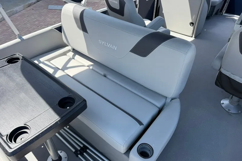 Slide: The Image of 2022 Sylvan L3 DLZ boat interior with gray seating and black table. - 10