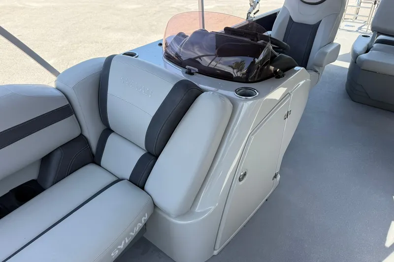 Slide: The Image of 2022 Sylvan L3 DLZ boat interior with gray seating and helm console. - 24