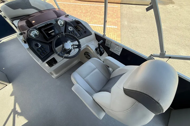 Slide: The Image of Interior view of 2022 Sylvan L3 DLZ boat cockpit with steering wheel and control panel. - 14