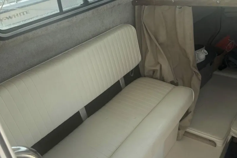 Slide: The Image of Interior of a 2004 Parker 2520 Modified Vee Sport Cabin with beige seating. - 7