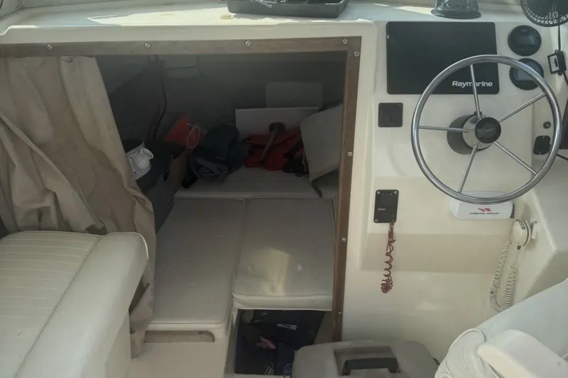 Slide: The Image of 2004 Parker 2520 Modified Vee Sport Cabin interior with steering wheel and cabin entrance. - 9