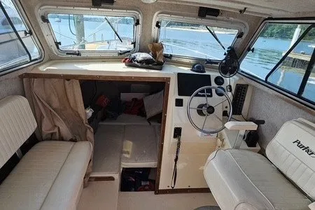 Slide: The Image of 2004 Parker 2520 Modified Vee Sport Cabin interior with steering wheel and seating. - 3