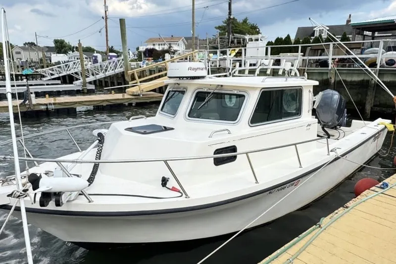 The Image of 2004 Parker 2520 Modified Vee Sport Cabin boat docked at marina. - 0