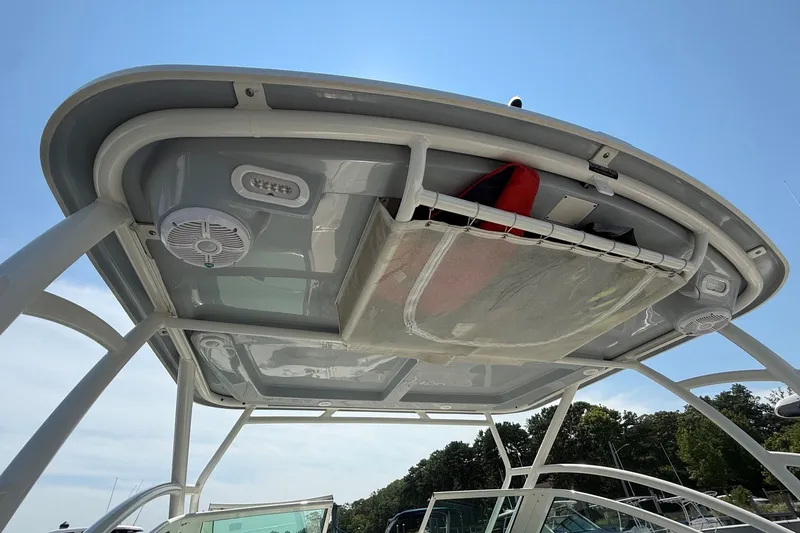 Slide: The Image of 2022 Sailfish 245 DC boat canopy with speakers and storage compartment. - 18