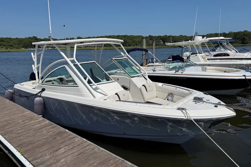 Slide: The Image of 2022 Sailfish 245 DC boat docked at marina on a sunny day. - 1