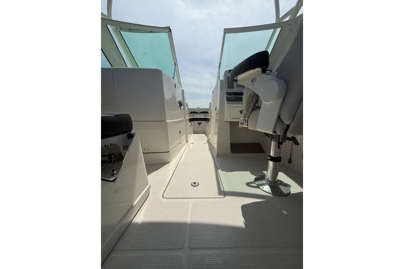 Slide: The Image of 2022 Sailfish 245 DC boat interior with seating and helm, showcasing modern design. - 15