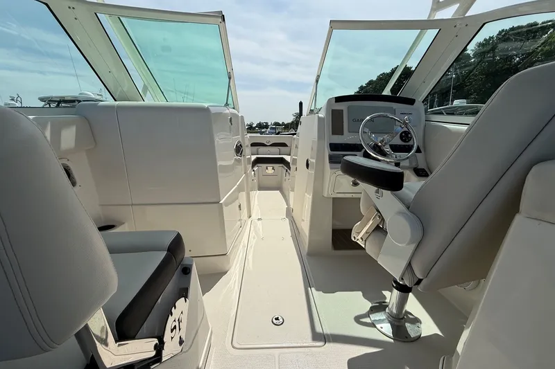 Slide: The Image of Interior view of 2022 Sailfish 245 DC boat, featuring helm and seating area. - 13