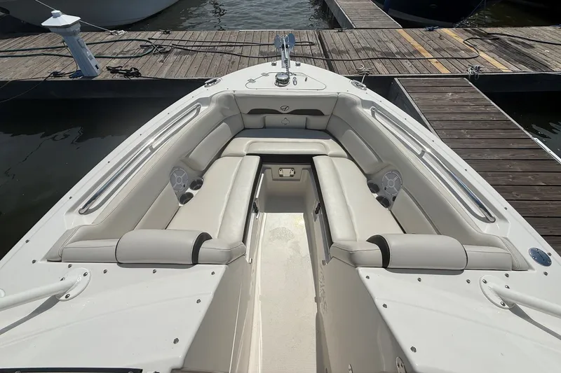 Slide: The Image of 2022 Sailfish 245 DC boat interior with spacious seating at dock. - 20