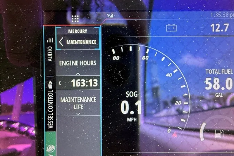 Slide: The Image of Display screen of a 2022 Sailfish 245 DC showing engine hours and fuel level. - 17