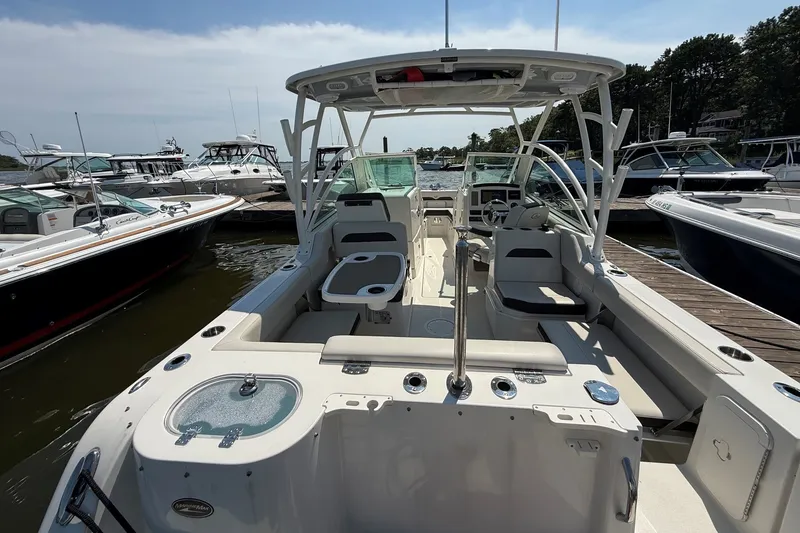 Slide: The Image of 2022 Sailfish 245 DC boat docked, featuring spacious seating and modern design. - 3