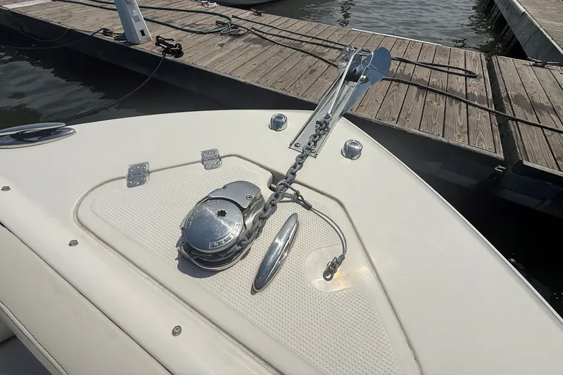 Slide: The Image of Bow of 2022 Sailfish 245 DC boat with anchor and winch at dock. - 22