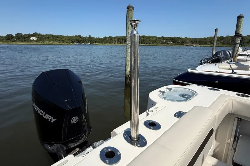Slide: The Image of 2022 Sailfish 245 DC boat with Mercury engine docked on a sunny day. - 4