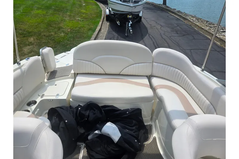 Slide: The Image of Interior of a 2007 Azure AZ228 boat with white seating and a black jacket. - 23