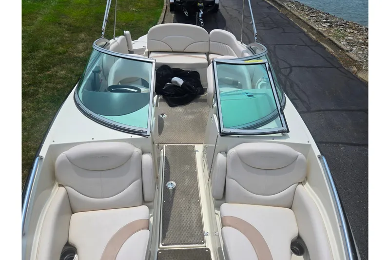 Slide: The Image of 2007 Azure AZ228 boat interior with white seating and windshield, parked near water. - 21