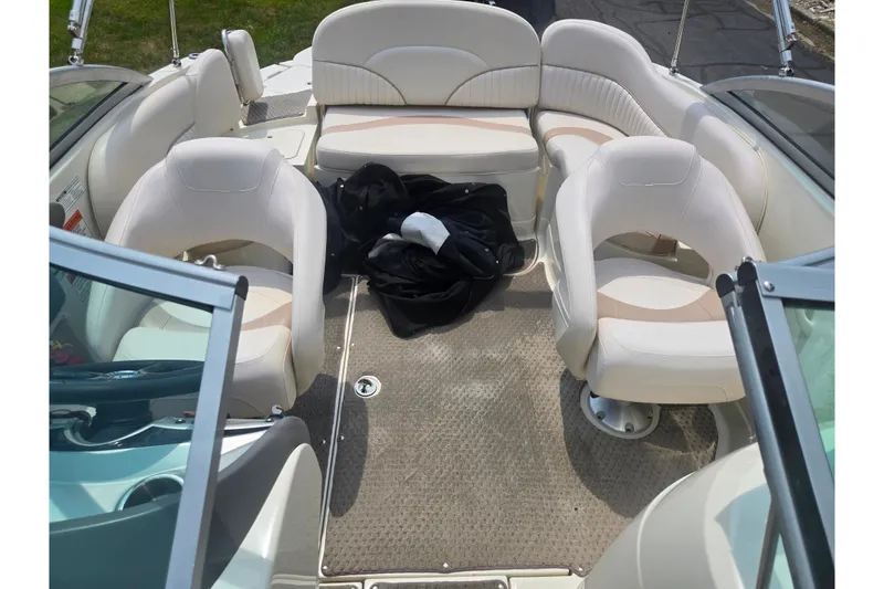 Slide: The Image of Interior of a 2007 Azure AZ228 boat with white seating and carpeted floor. - 22