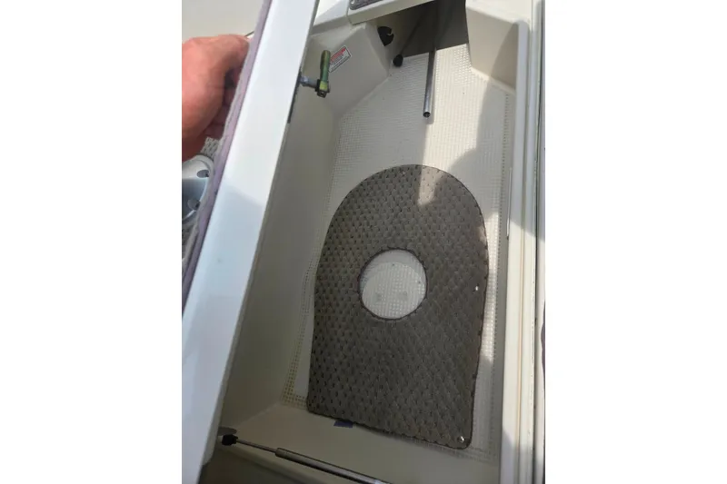 Slide: The Image of Storage compartment in a 2007 Azure AZ228 boat with a textured mat. - 14
