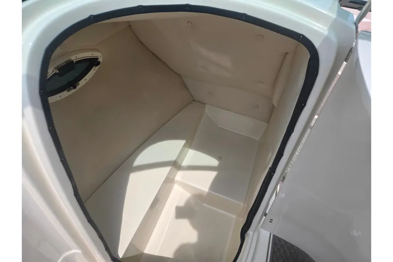 Slide: The Image of Interior cabin of 2007 Azure AZ228 boat, featuring a compact, beige space. - 16