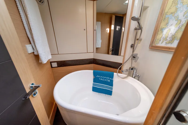 Slide: The Image of Luxurious bathroom in 2016 Jeanneau 64 yacht with bathtub and shower. - 45