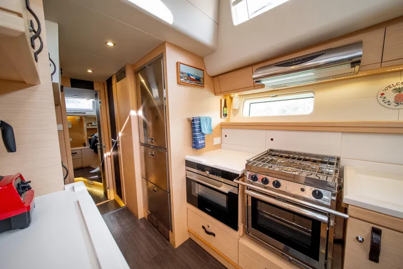Slide: The Image of Luxurious 2016 Jeanneau 64 yacht kitchen with modern appliances and sleek design. - 32