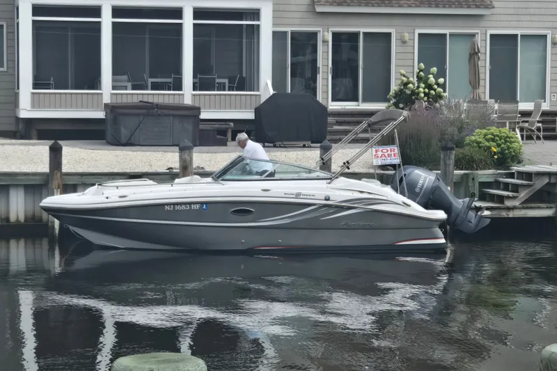 The Image of 2013 Hurricane SunDeck Sport 220 OB boat docked, for sale sign visible. - 0