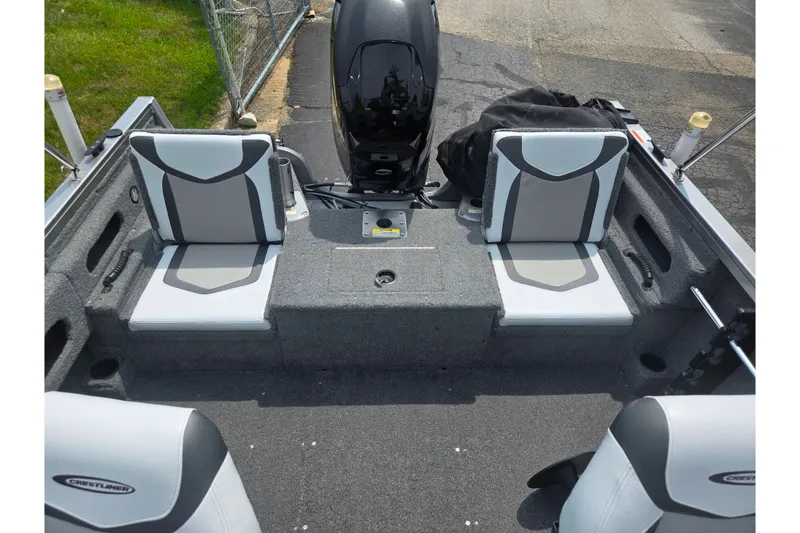 Slide: The Image of 2014 Crestliner 1650 Super Hawk boat interior with gray seating and motor. - 25