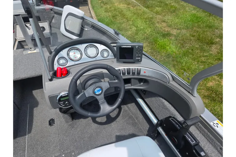 Slide: The Image of 2014 Crestliner 1650 Super Hawk dashboard with steering wheel and navigation system. - 14