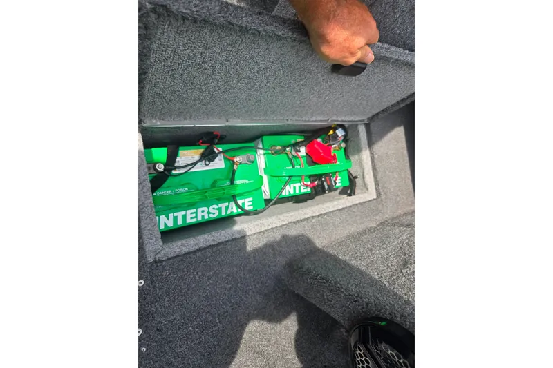 Slide: The Image of 2014 Crestliner 1650 Super Hawk boat battery compartment with Interstate battery visible. - 16