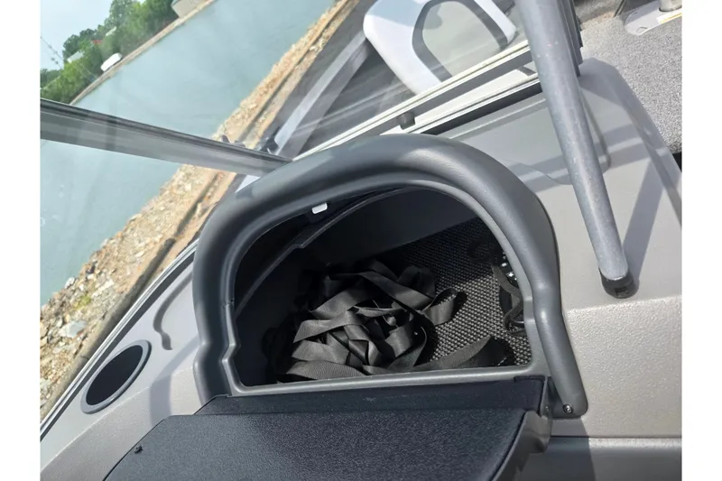 Slide: The Image of 2014 Crestliner 1650 Super Hawk boat interior with storage compartment and lake view. - 17