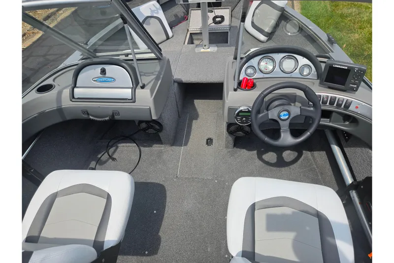 Slide: The Image of 2014 Crestliner 1650 Super Hawk boat interior with steering wheel and dashboard controls. - 13