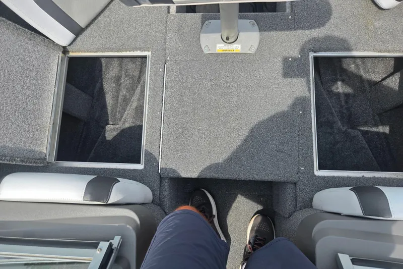 Slide: The Image of Interior view of a 2014 Crestliner 1650 Super Hawk boat with open storage compartments. - 19