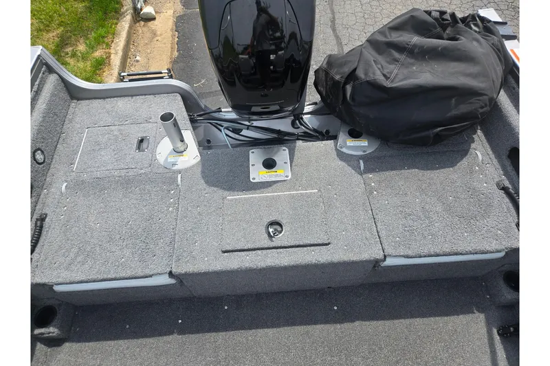 Slide: The Image of 2014 Crestliner 1650 Super Hawk boat deck with motor and storage compartments. - 27