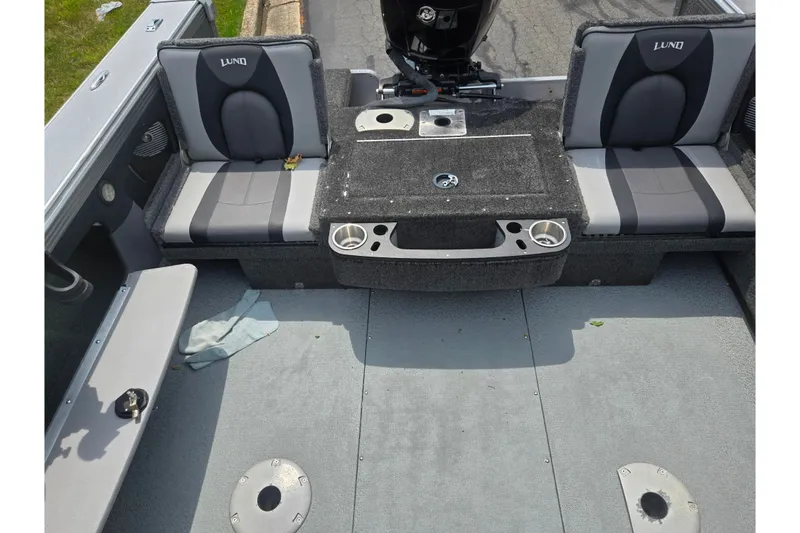 Slide: The Image of 2014 Lund 1900 Tyee boat interior with gray seating and carpeted flooring. - 26