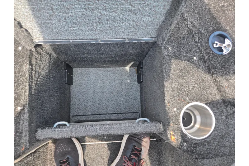 Slide: The Image of Interior view of 2014 Lund 1900 Tyee boat storage compartment with cup holder. - 20