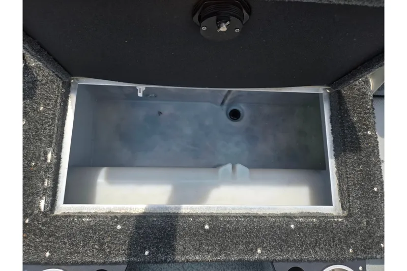Slide: The Image of Open storage compartment in 2014 Lund 1900 Tyee boat, featuring carpeted edges. - 27