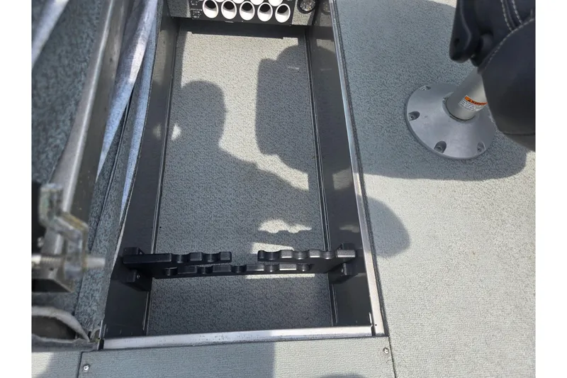Slide: The Image of Interior view of a 2014 Lund 1900 Tyee boat, featuring rod storage compartment. - 13