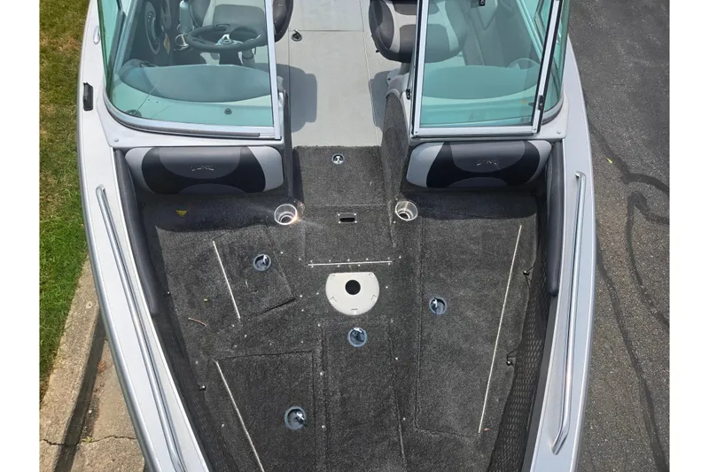 Slide: The Image of 2014 Lund 1900 Tyee boat interior with carpeted deck and seating. - 23