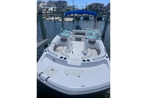 Slide: The Image of 2014 Hurricane SunDeck 187 OB boat docked at marina with blue canopy. - 3
