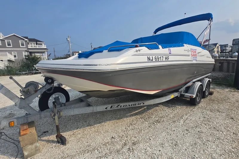Slide: The Image of 2014 Hurricane SunDeck 187 OB boat on trailer, for sale, with blue cover. - 8