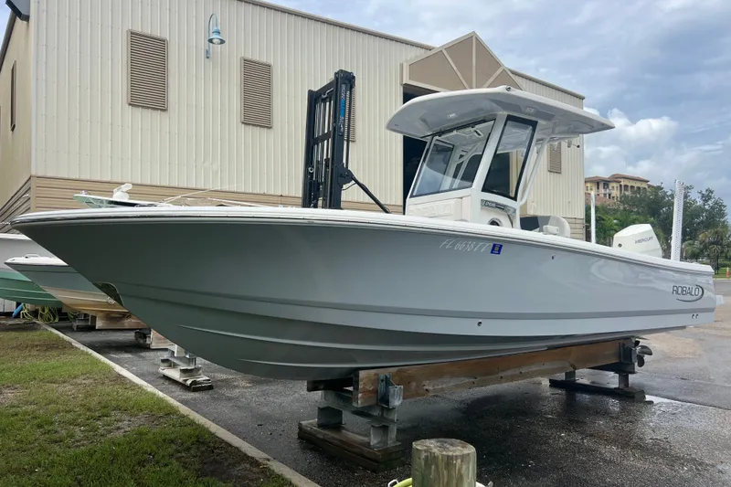 The Image of 2024 Robalo 266 Cayman boat on display outside a storage facility. - 0
