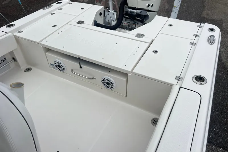 Slide: The Image of 2024 Robalo 266 Cayman boat deck with storage compartments and speakers. - 14
